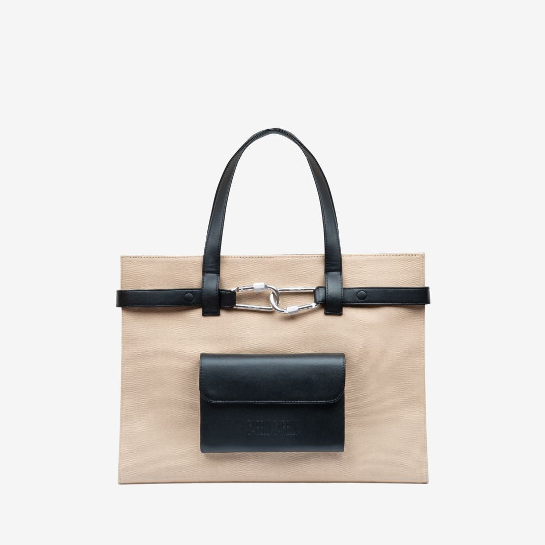 Beige cargo tote bag with leather flap and handle on a light gray background