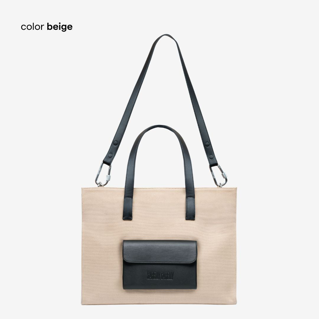 Beige cargo tote bag with leather flap and strap on a white background