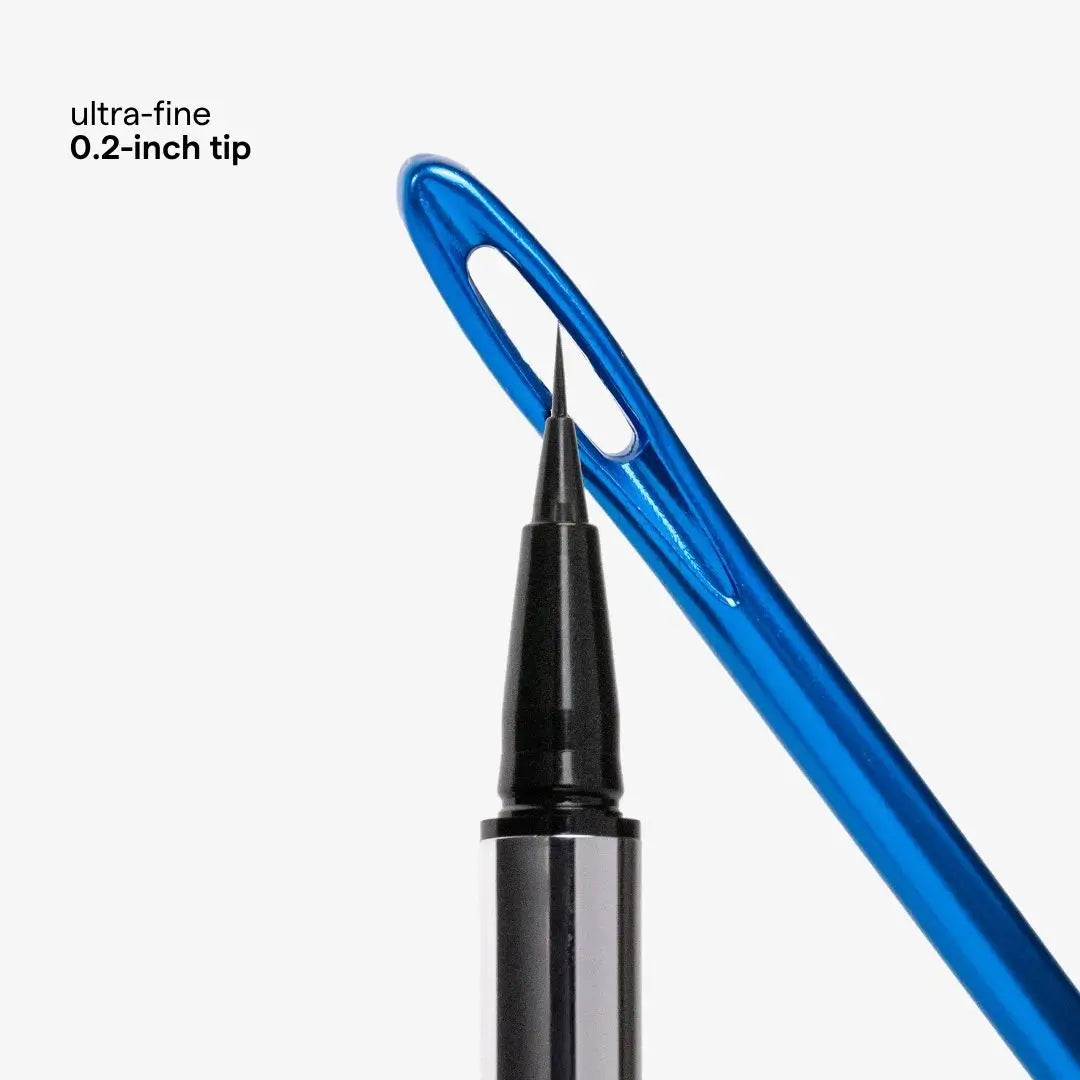 Close-up of a blue transparent needle with a black and silver pen-like tip touching it, on a light gray background. Small text in the upper left reads 'ultra-fine 0.