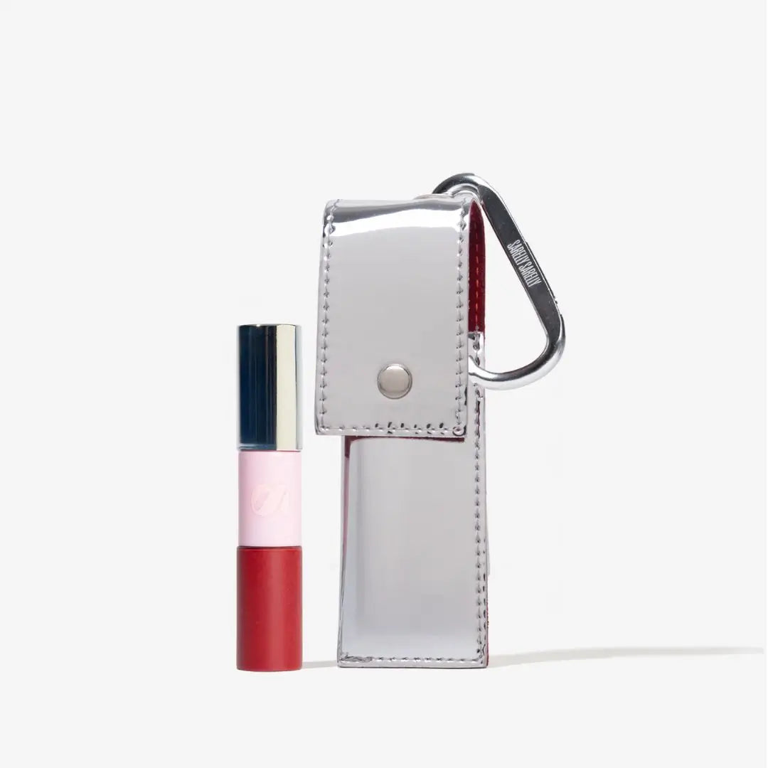 Lipstick product with packaging and a red pouch on a light background.