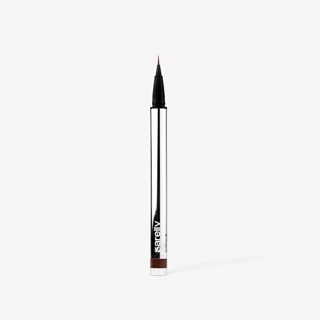 A slim chocolate and silver cosmetic pen with a fine tip, standing vertically on a light gray background. The brand name sarelly is printed in white near the bottom of the pen barrel.