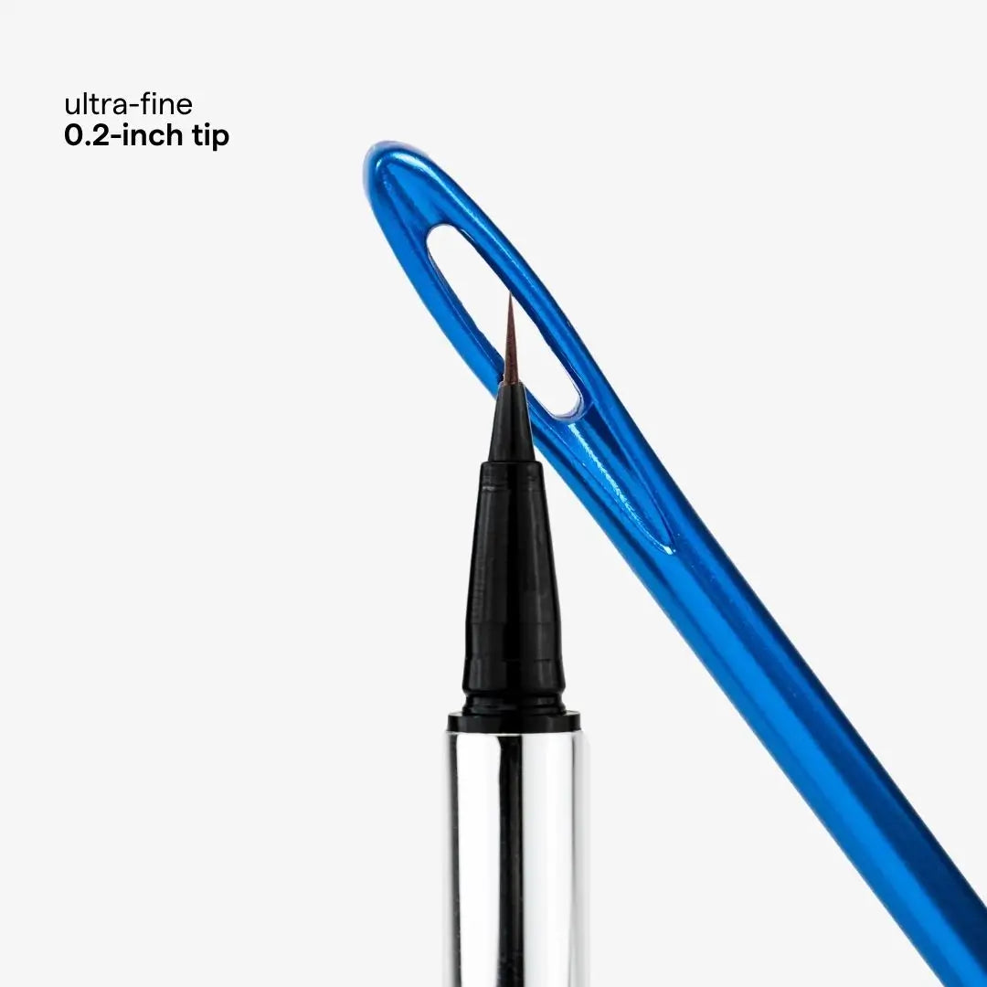 Close-up of a fine-tip sewing pen with a translucent blue handle, shown against a light gray background with text reading 'ultra-fine 0.2-inch tip'. Shade Chocolate