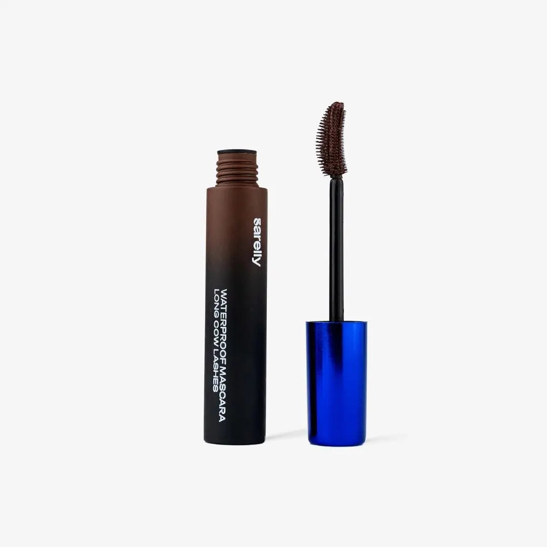 A chocolate mascara tube with white text stands next to its open blue cap and wand on a clean white background.