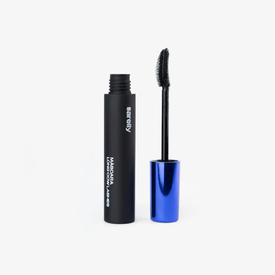 A black mascara tube with white text stands next to its open blue cap and black wand on a clean white background.
